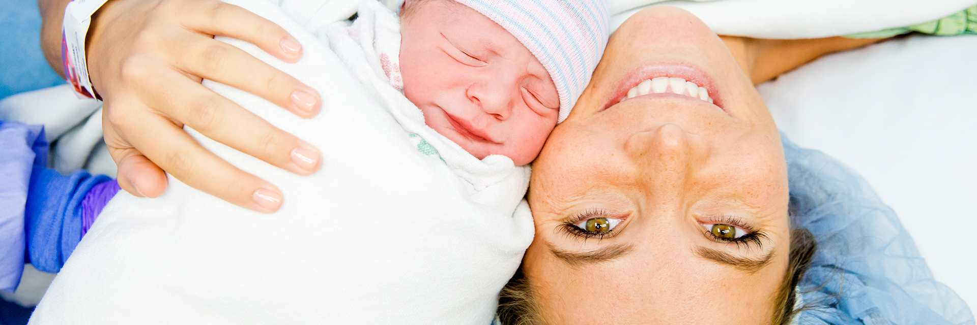 Mom posing with newborn baby