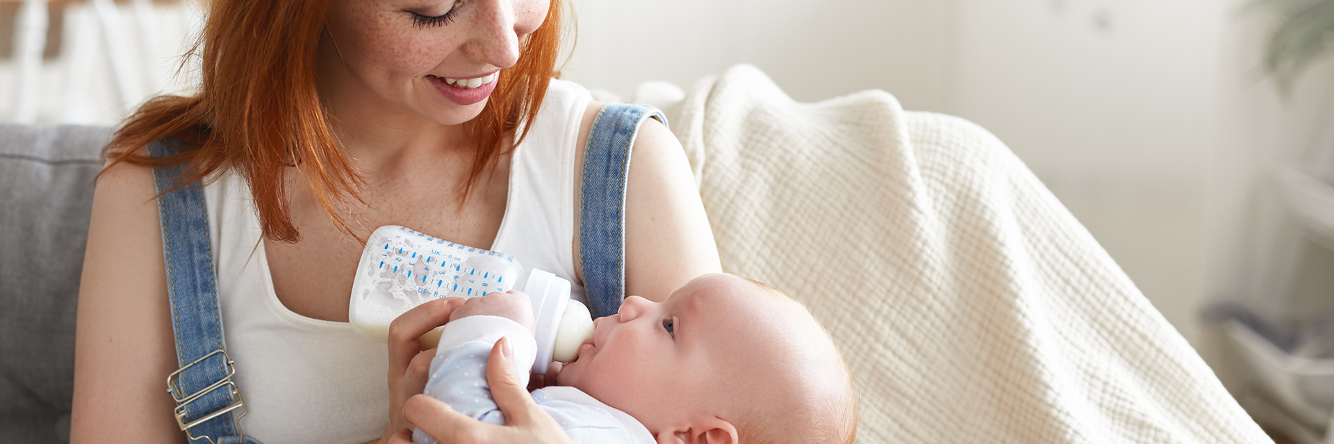 Mom bottle feeding baby