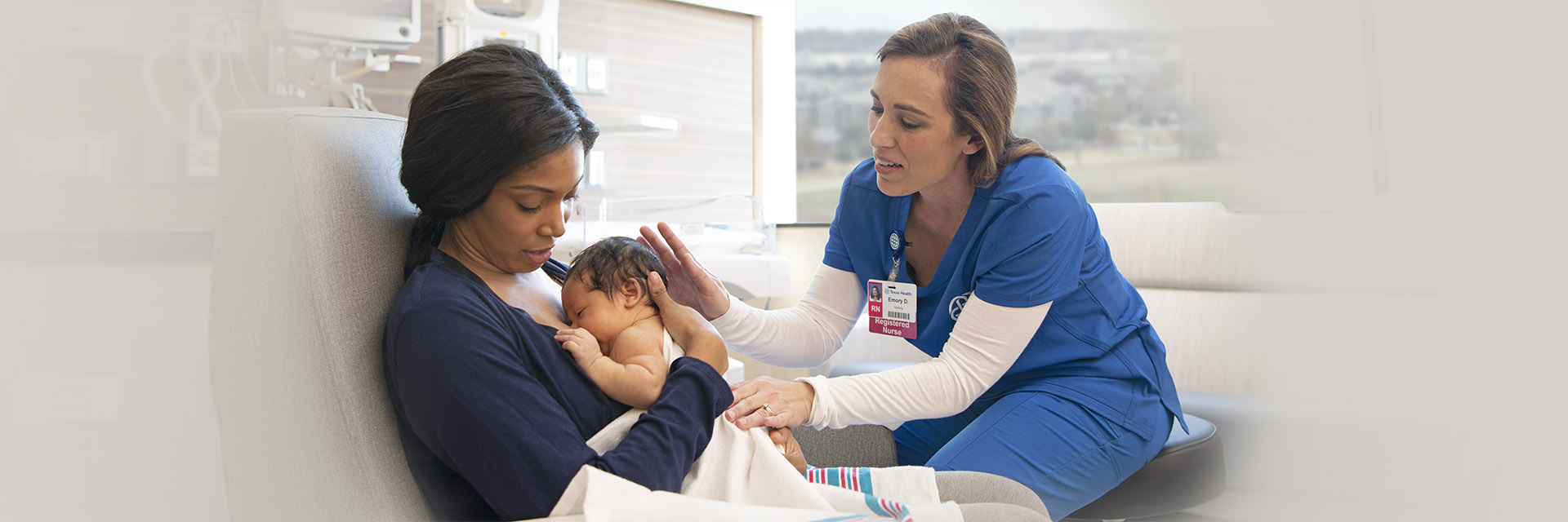 Mom learning to breastfeed as nurse wwatches