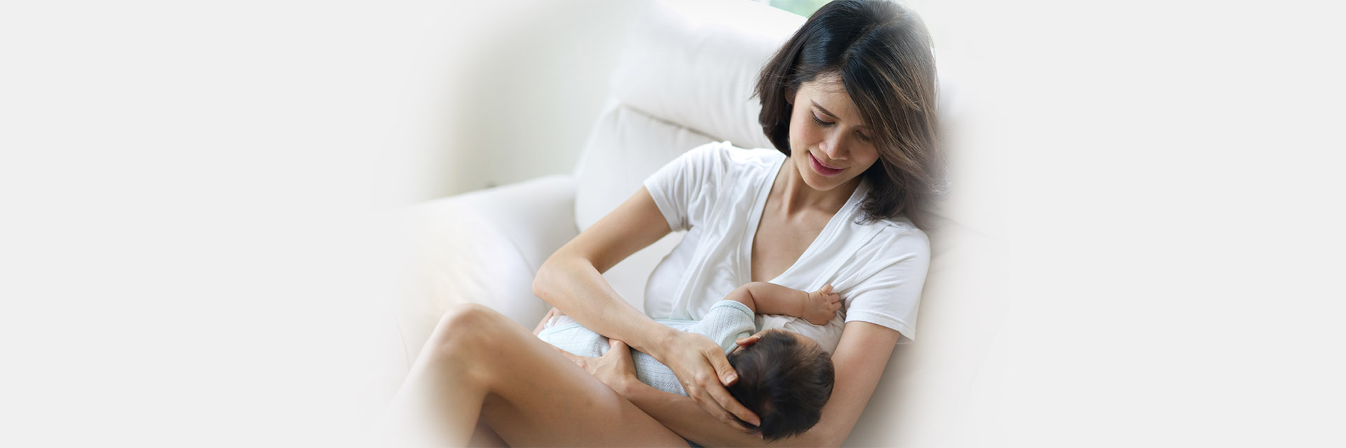 Mom watching baby breastfeed