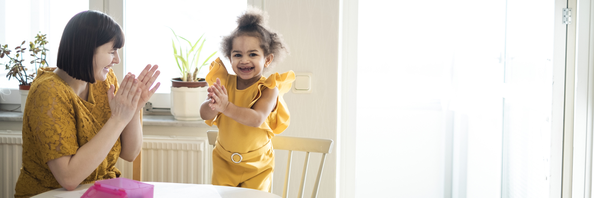 Mom and daughter clapping
