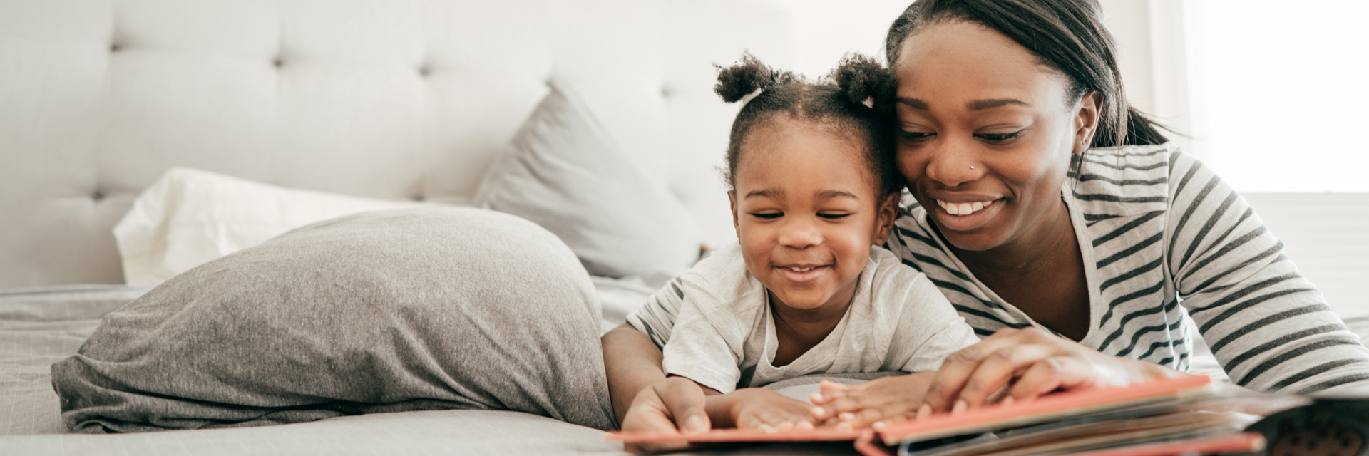Mom and daughter reading on the couch