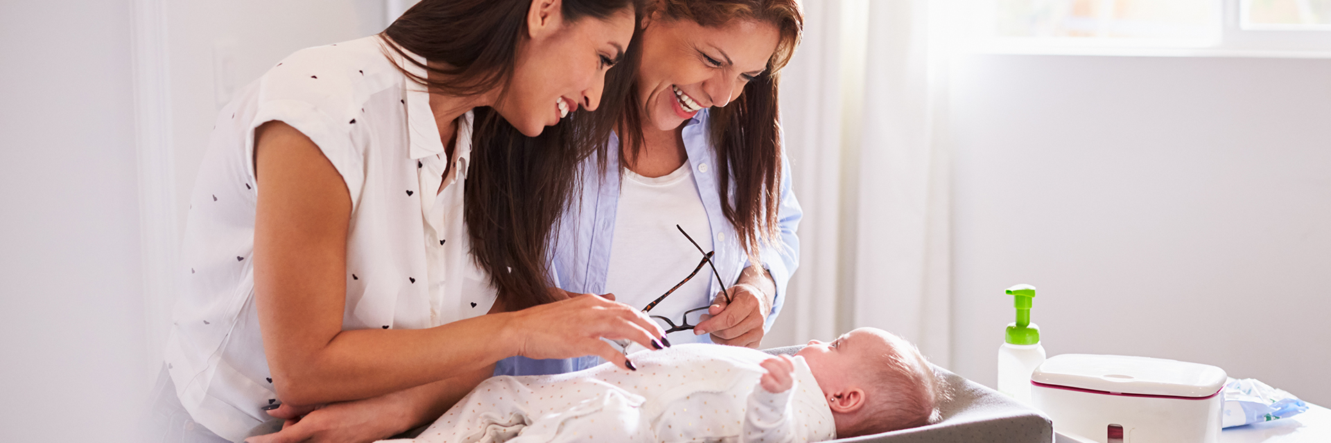 2 women looking at a new baby
