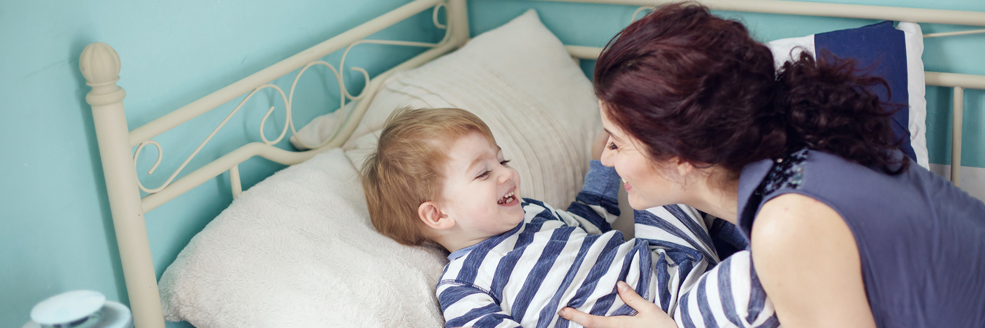 Mom playing with son at bedtime