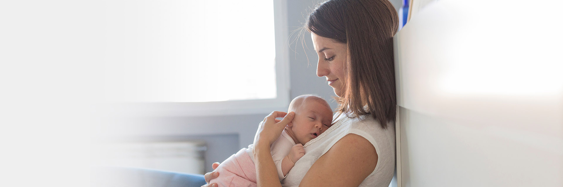 New mom cuddling newborn
