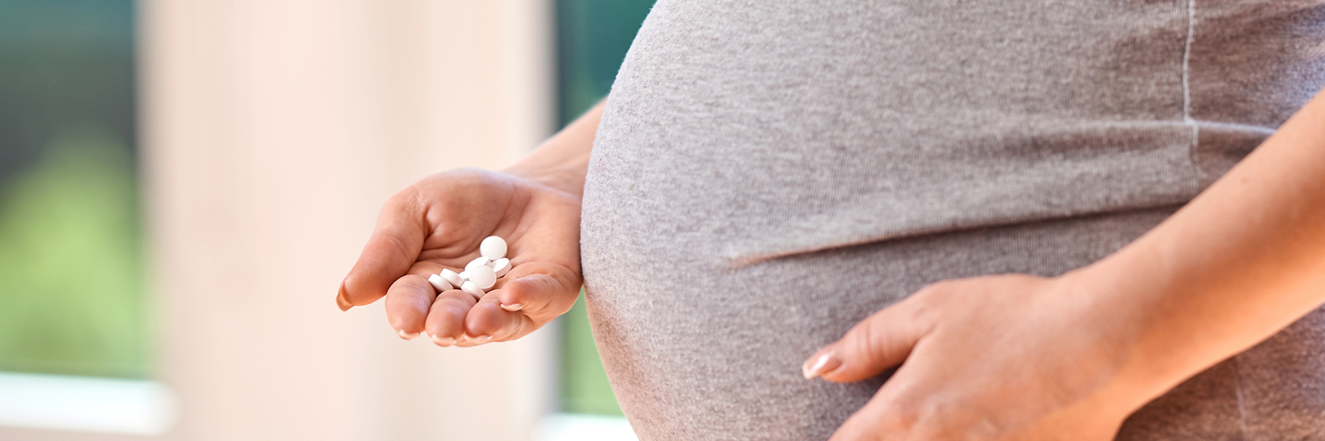 Pregnant belly holding pills