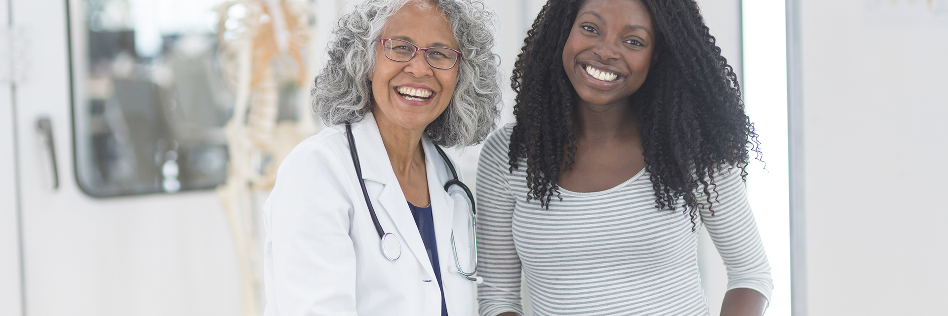 Pregnant woman and her doctor smiling 
