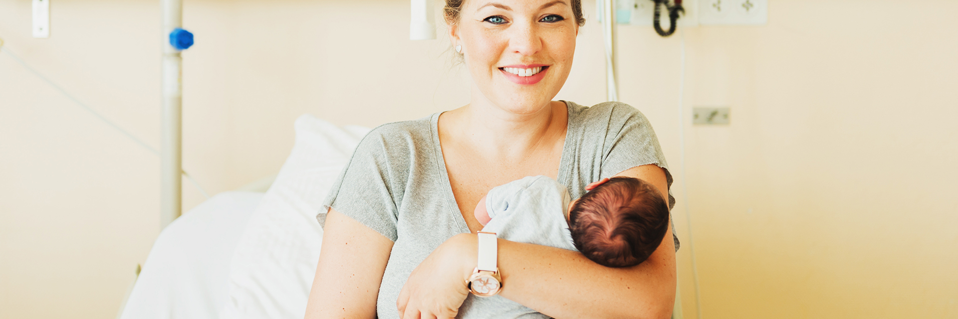 Woman holding infant in exam room