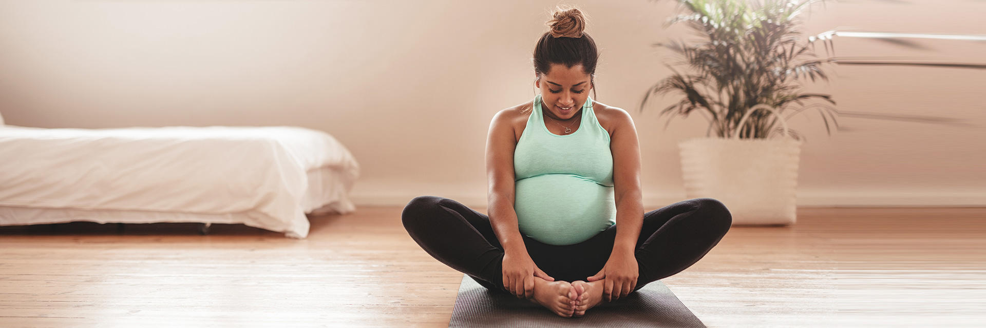 Pregnant Woman doing Yoga Stretch