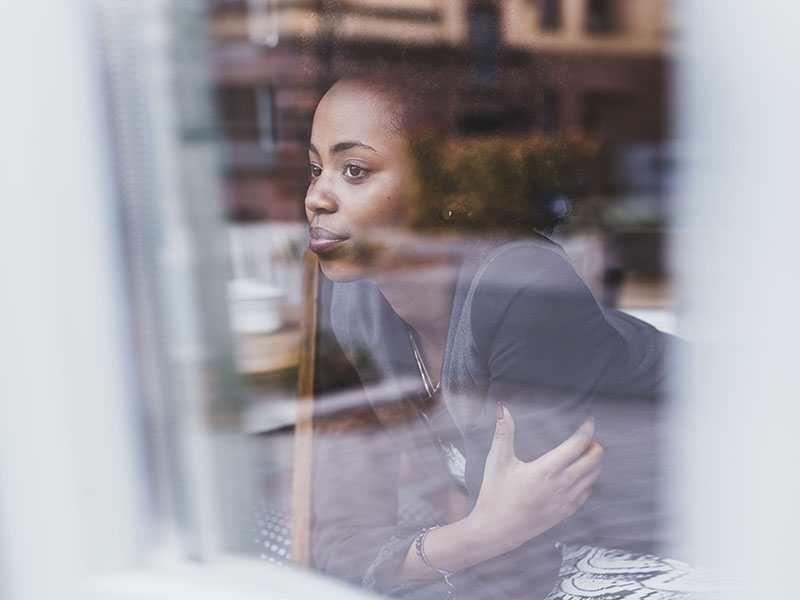 Young woman looking out of the window