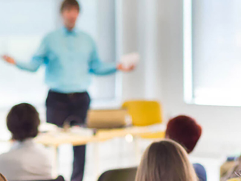 Man Standing in Front of a Classroom