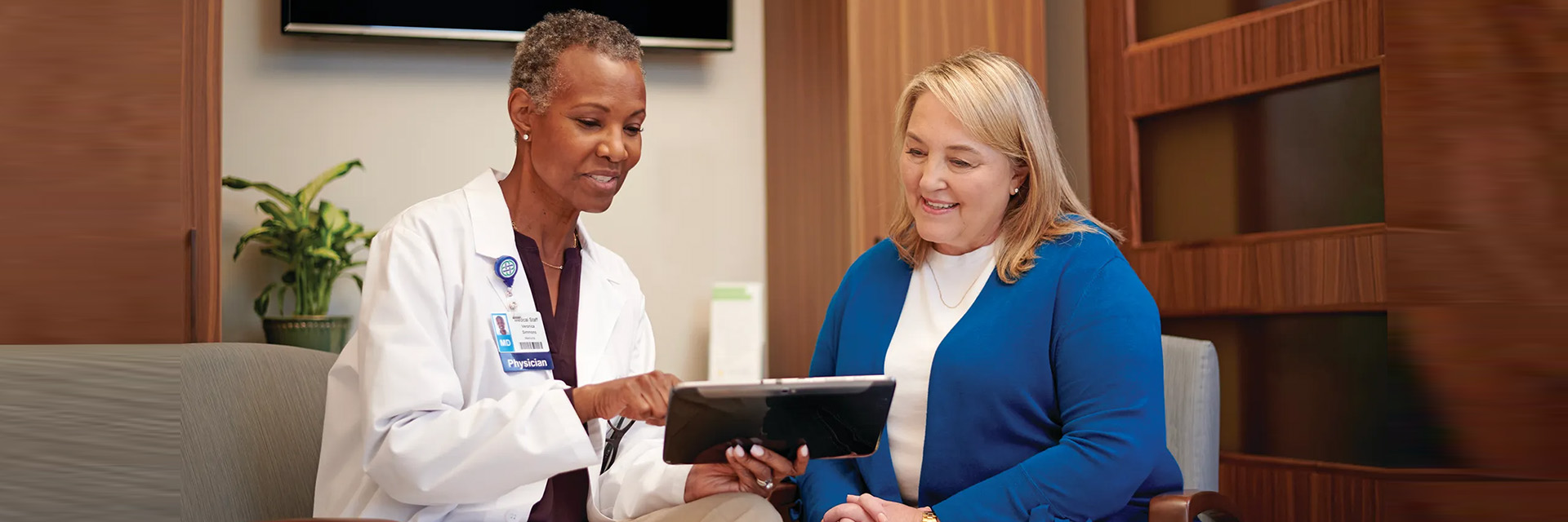 Doctor showing patient tablet