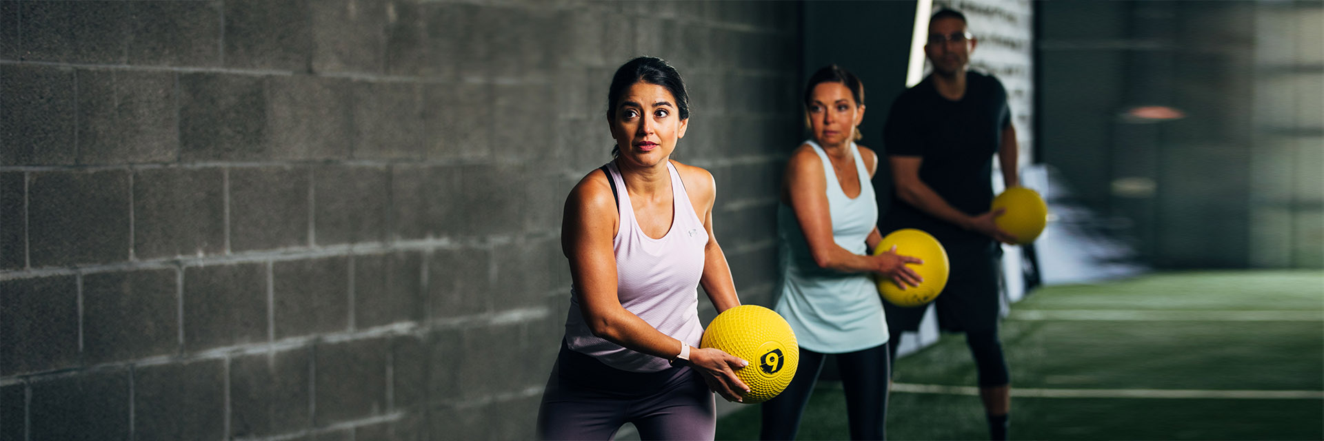 Three people exercising in the gym