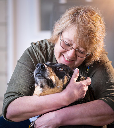 Debra Hardy Hugs Her Dog