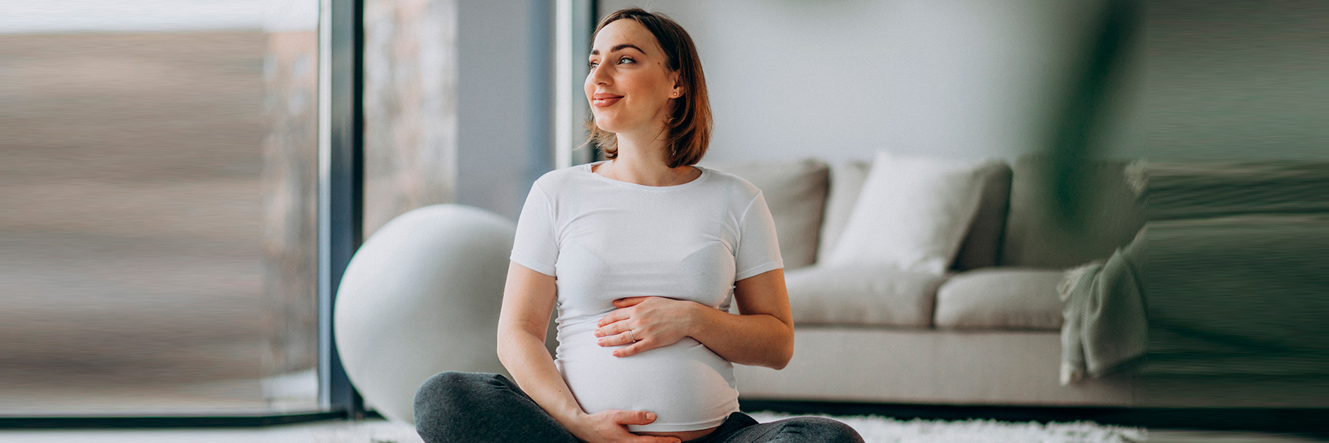 Pregnant Woman on Floor Holding Stomach