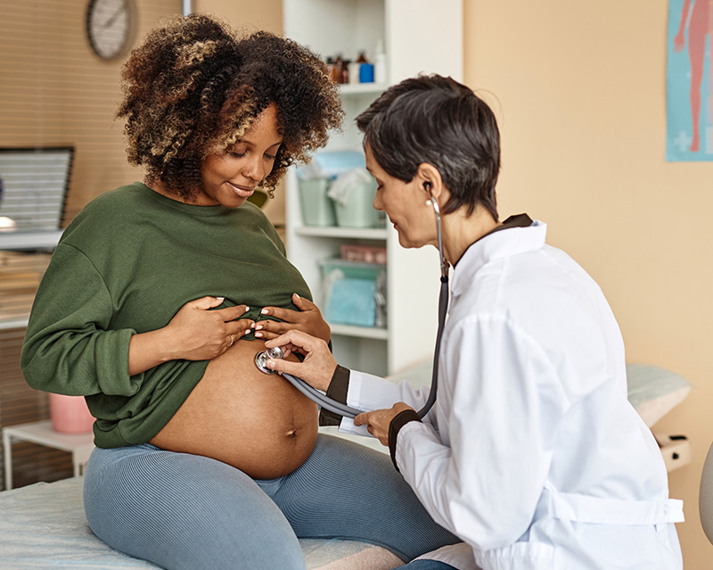 Pregnant woman with doctor