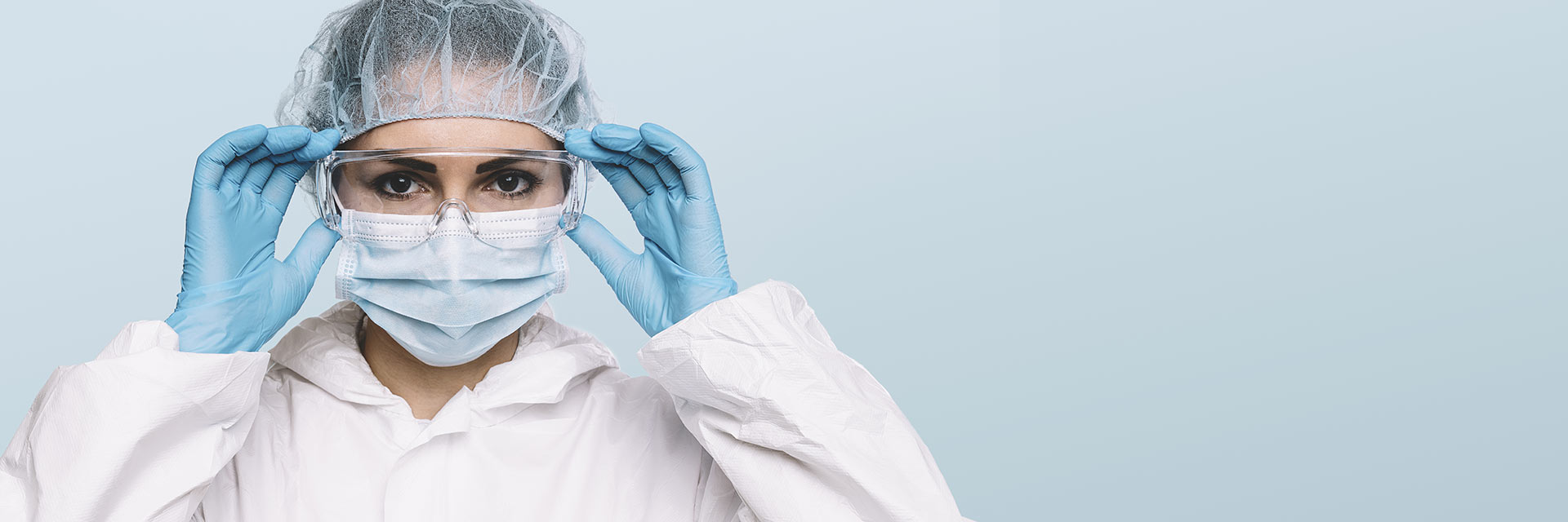 Woman with mask, gloves, and goggle