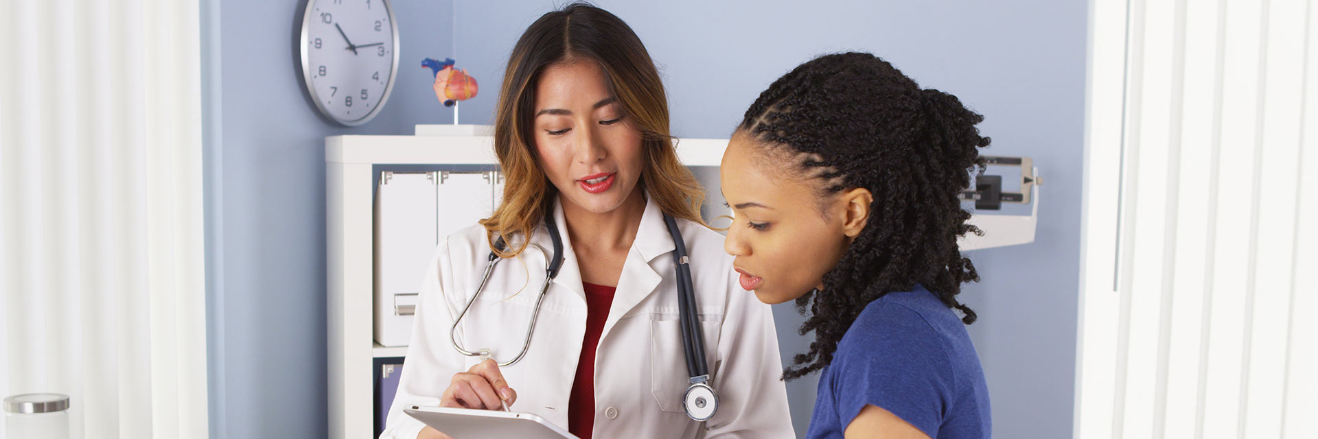 Doctor showing tablet to patient