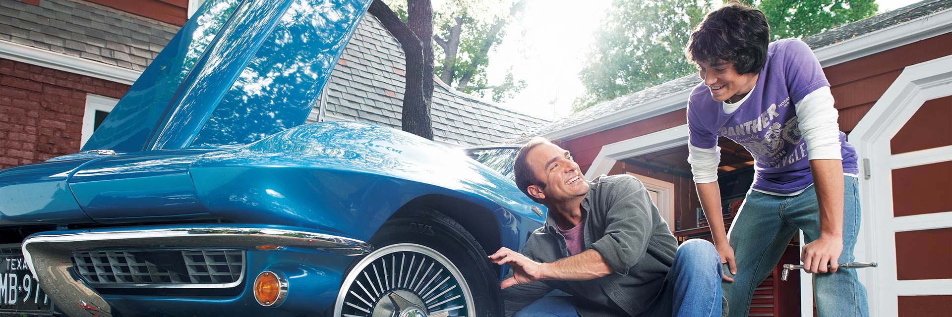 Father and son working on car