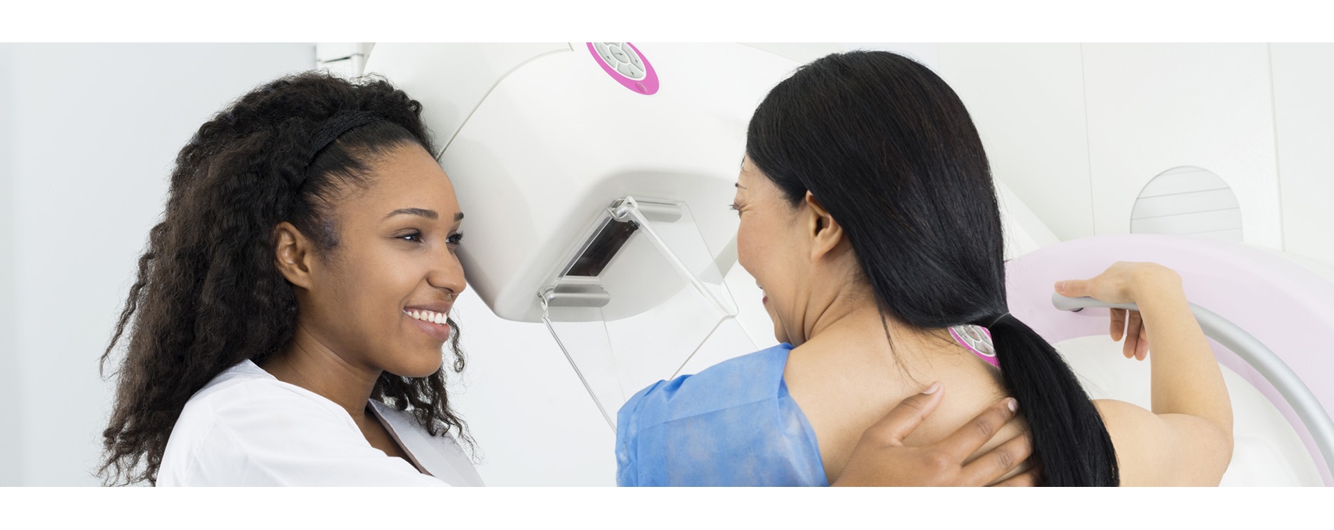 Female doctor giving patient mammogram