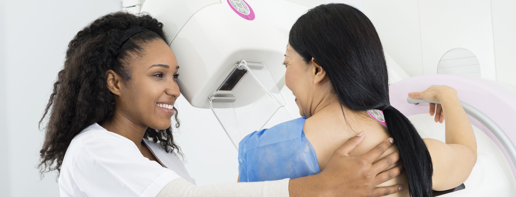 Female doctor giving patient mammogram