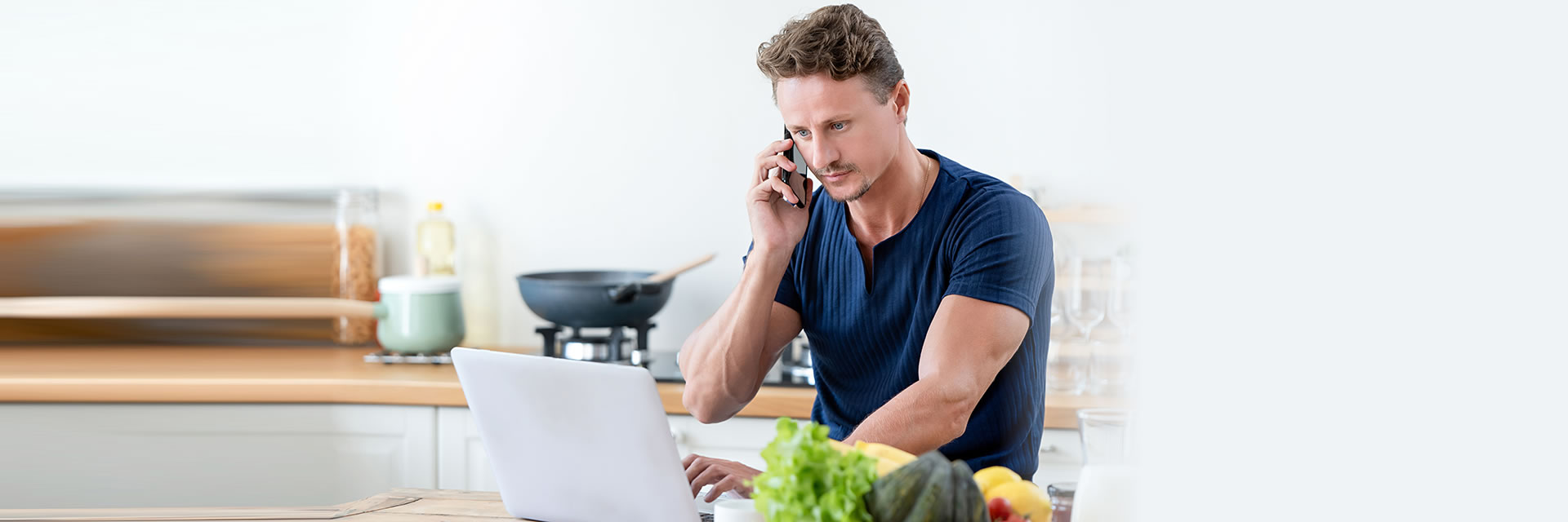 Man on phone using laptop