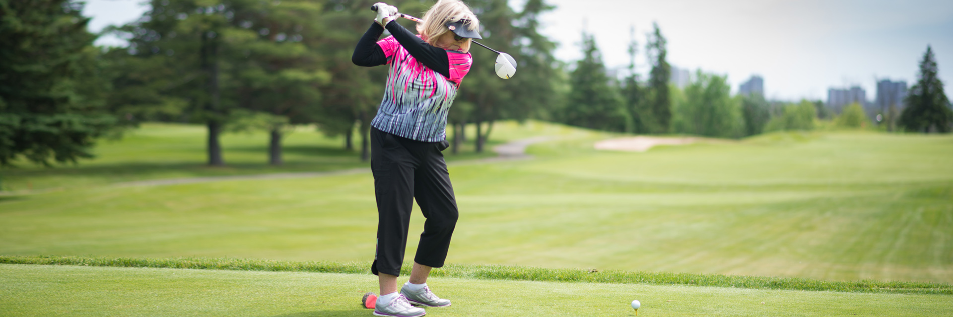 Mature woman golfing
