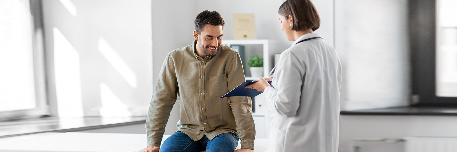 Man and a female provider in an exam room