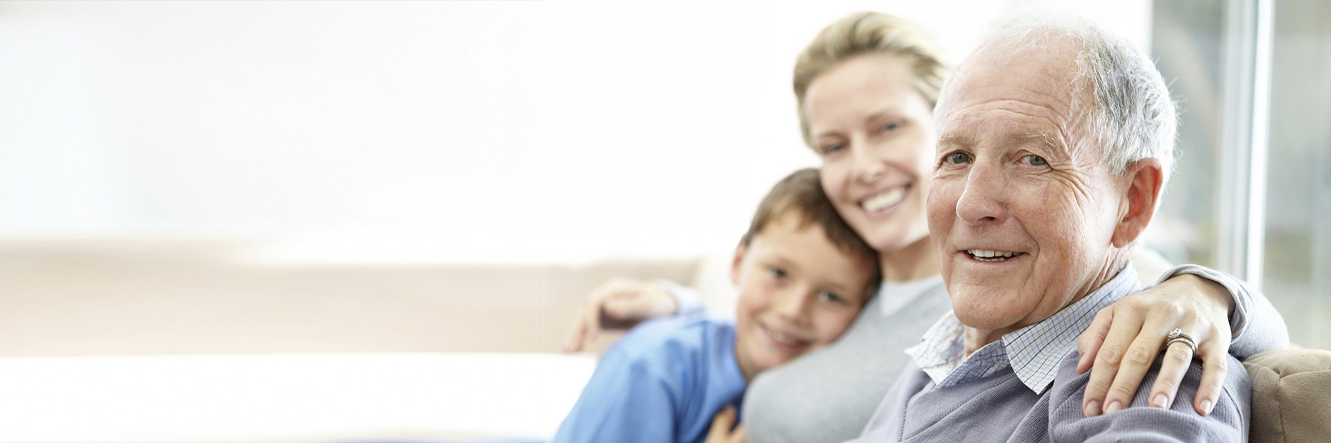 Senior Man Sitting with Daughter and Grandson