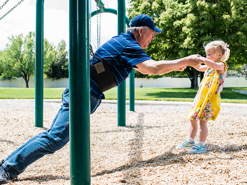 Grandfather and Granddaughter on Swing