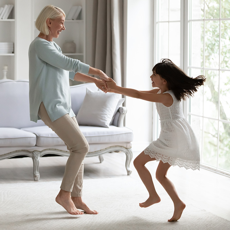 Grandmother and granddaughter dancing