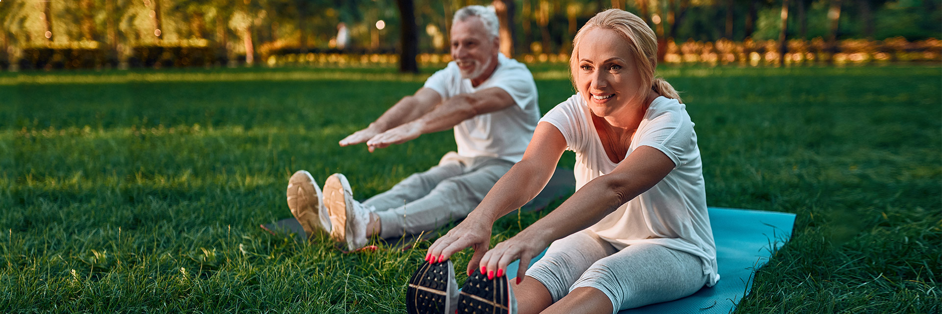 Mature Couple doing in yoga outdoors