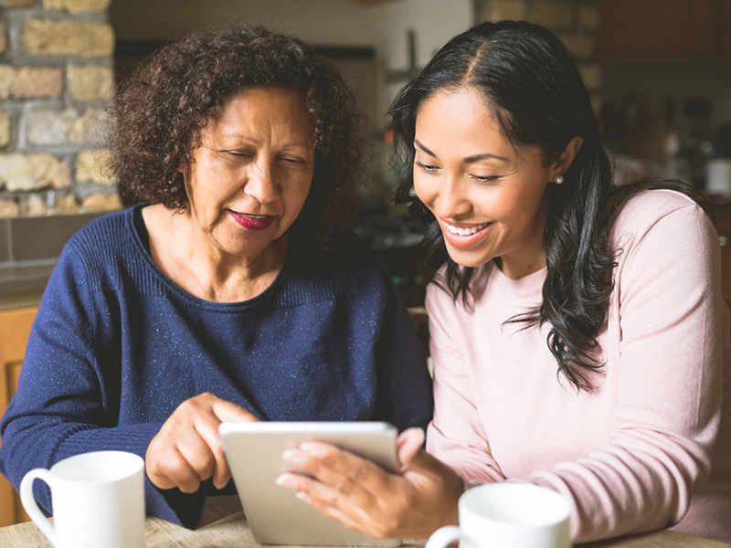 Two woman using tablet