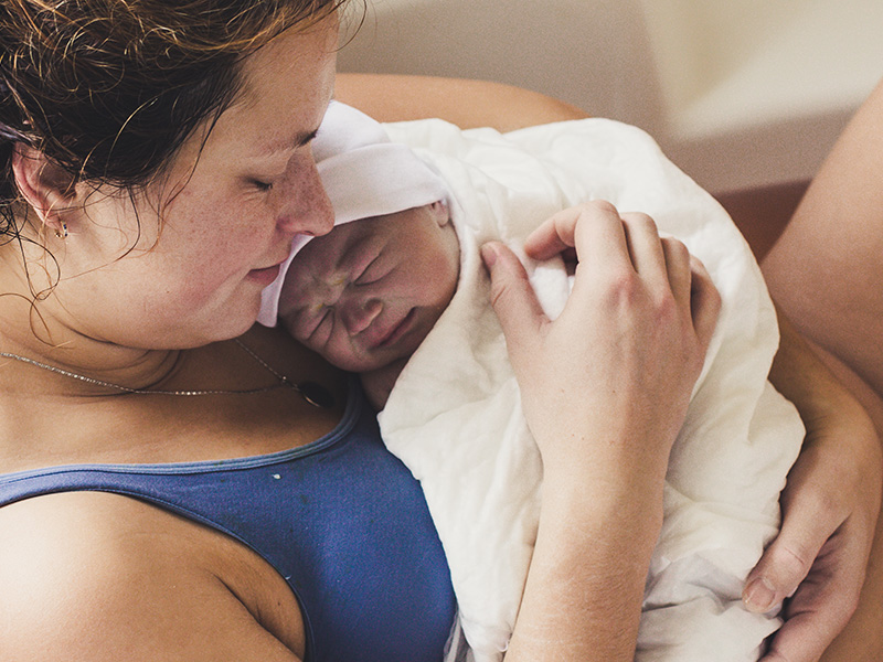 Woman holding newborn baby