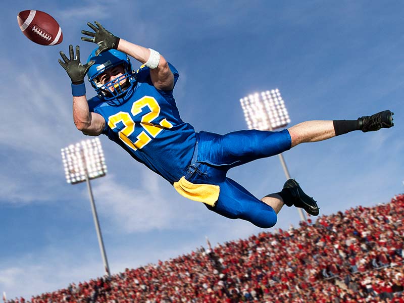 Football player catching ball